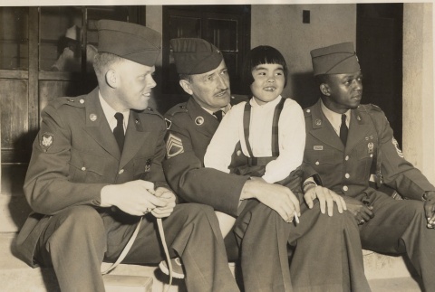 Hugh F. O'Reilly and two other Wolfhounds posing with a young girl (ddr-njpa-2-777)