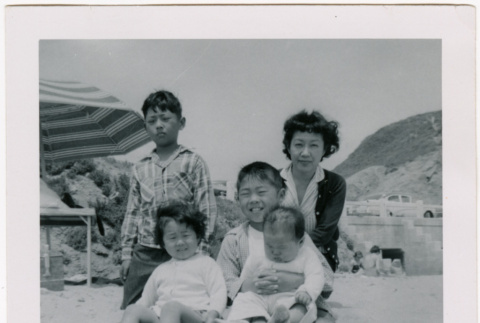 Yoshiko, William, Susan and Leslie Shiomi on beach with unidentified boy (ddr-densho-522-364)