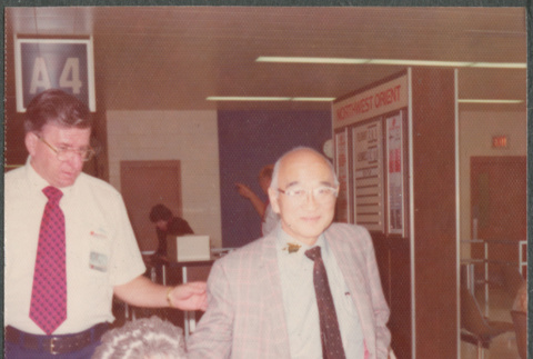 Chester Sakura with Agnes Sakura in wheelchair at airport (ddr-densho-523-661)