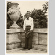 Man posing next to a statue (ddr-densho-542-795)