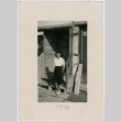 Woman poses on barrack steps (ddr-densho-363-10)