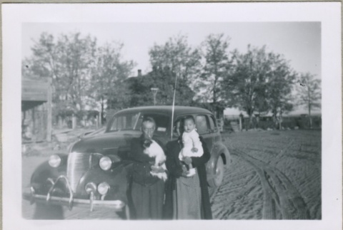 A family standing in front of a car (ddr-densho-300-34)