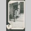 Masao Sakagami crouching on front steps (ddr-densho-328-41)