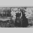 Two women holding chrysanthemums (ddr-densho-34-25)