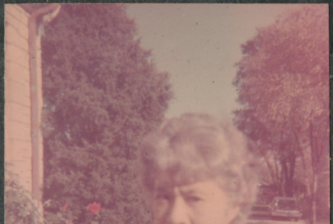 Woman holding sunglasses (ddr-densho-523-637)