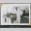 Man standing by large pots in kitchen (ddr-densho-434-283)