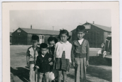 Five children outside barracks at Minidoka (ddr-densho-543-1)