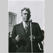 Man standing at microphone (ddr-densho-426-1038)