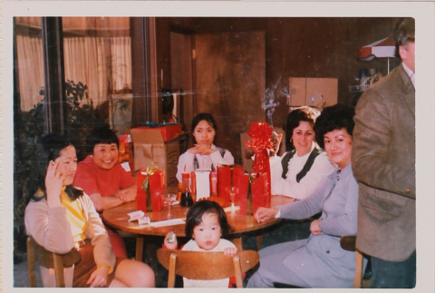 Five people and small child seated at table with gifts (ddr-densho-426-1220)