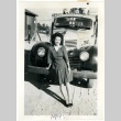 Woman standing in front of a truck (ddr-manz-6-84)