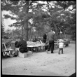 Man and child walking by small market stand (ddr-densho-426-276)