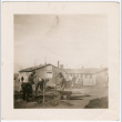 Men planting trees near barracks (ddr-densho-329-1389)