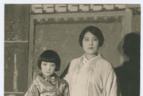 Postcard photograph of woman and girl in kimonos (ddr-densho-383-434)