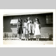 Women pose in front of building (ddr-csujad-26-84)
