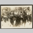 German soldiers and boys with flowers walking in a crowd (ddr-njpa-13-900)