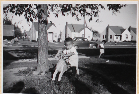Child on toy horse (ddr-densho-522-72)