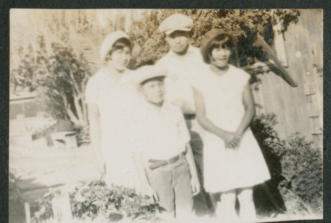 two boys and two girls outside in a yard (ddr-densho-378-691)