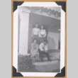 Four people posing on a porch (ddr-densho-542-310)
