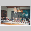 Takeo Isoshima with many cupcakes (ddr-densho-477-636)