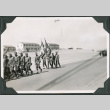 Group of men marching with flags (ddr-ajah-2-46)