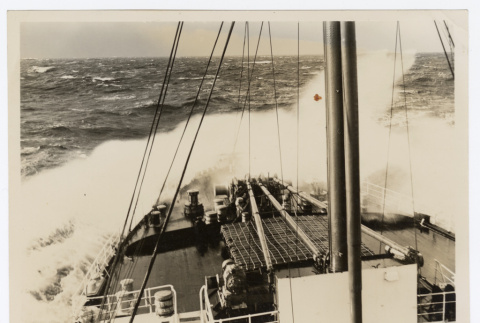 Wave crests the hull of a ship (ddr-densho-404-431)
