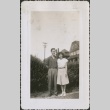A couple in front of houses (ddr-densho-298-200)