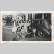 Members of a women's basketball team in front of a car (ddr-manz-10-4)
