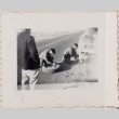 Three men changing a tire (ddr-densho-464-136)