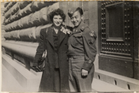 Soldier standing with women outside building (ddr-densho-466-318)