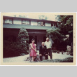 Three people sitting outside house (ddr-densho-377-1344)