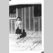 Japanese American woman in front of barracks (ddr-densho-157-21)