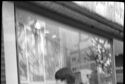 Boy looking in shop window (ddr-densho-426-2354)