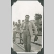 A man on a boardwalk (ddr-densho-300-223)
