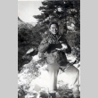 Lloyd Hidemasa Toda standing in snow, eating from mess kit (ddr-densho-474-228)