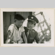 Sgt. Komoto shows his Purple Heart medal to a boy (ddr-densho-37-996)