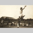 Chuhei Nambu practicing the long jump while others look on (ddr-njpa-4-1352)