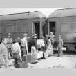 Indonesians boarding a train in San Francisco for the immigration detention facility at Crystal City, Texas (ddr-csujad-27-7)