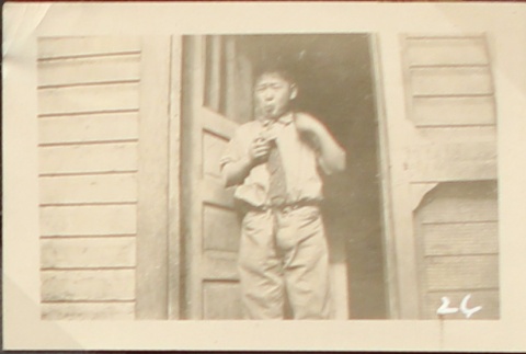 Nisei boy standing in doorway (ddr-densho-259-450)
