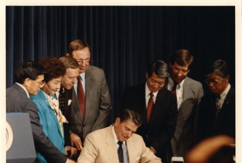 [Photograph of President Ronald Reagan signing the Civil Liberties Act of 1988 on August 10, 1988] (ddr-csujad-29-247)
