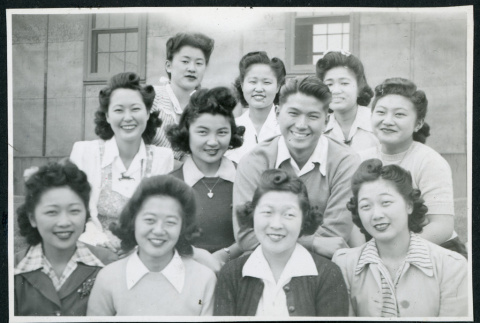 Photograph of people posing in front of a building at Manzanar (ddr-csujad-47-207)