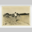 Man running on dirt track (ddr-csujad-44-13)