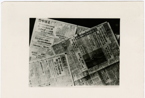 Stack of newspapers about Tokyo bombings and responses to the bombings (ddr-densho-381-116)
