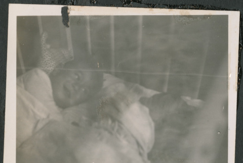 Photo of two children sharing a bed (ddr-densho-483-829)