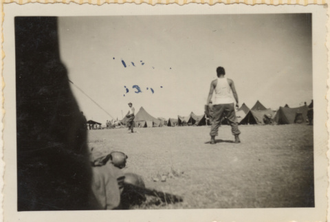 Two men playing catch near tents (ddr-densho-466-381)