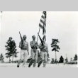 Three soldiers marching with a flag and rifles (ddr-densho-22-487)