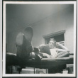 Man laying in bunk, reading (ddr-densho-434-486)