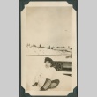 Woman sitting in the snow near train tracks (ddr-densho-321-136)