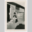 Two children by door of barracks (ddr-densho-329-1337)