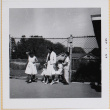 Yoshiko, William, Susan and Leslie Shiomi with unidentified girl standing by fence (ddr-densho-522-413)