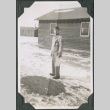Man standing in snow outside camp building (ddr-ajah-2-485)